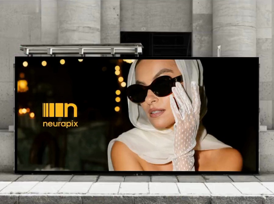 The Neurapix mark in yellow on a street billboard carrying a photographer’s image